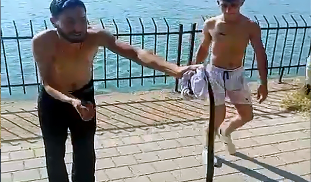 Nehirden çıkardıkları yılanın başını ezip, çakıyla keserek öldürdüler